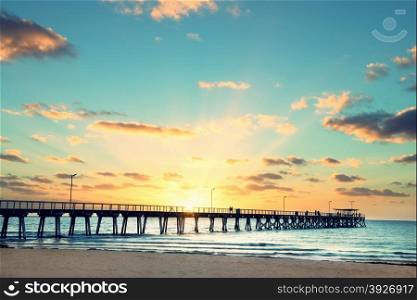 Beautiful sunset at Grange Jetty Adelaide Australia with peoples silhouettes
