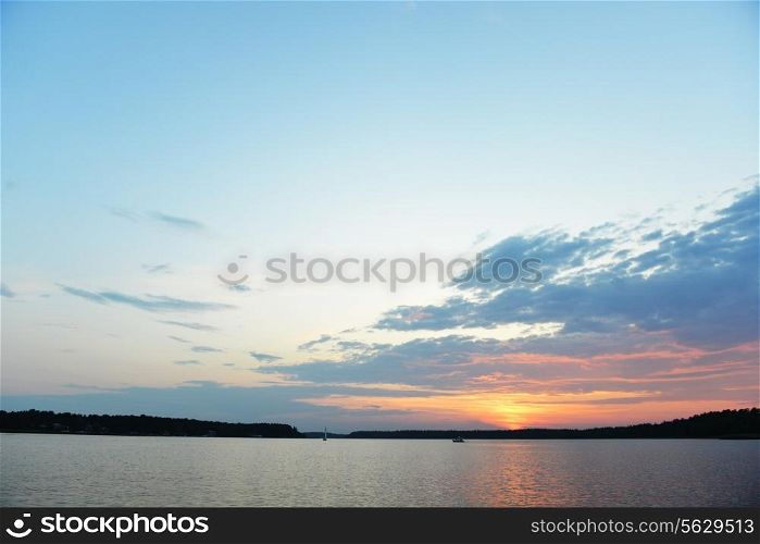 beautiful sunset at shore lake