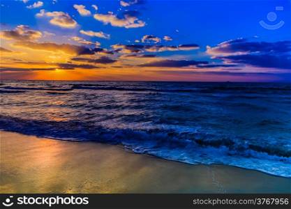 Beautiful sunset at the beach, amazing colors, light beam shining through the cloudscape over the arabian gulf seascape, united arab emirates. Dubai sea and beach