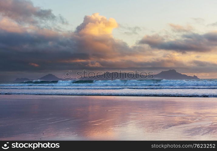 Beautiful Sunset at the Ocean Beach, New Zealand. Inspiring natural and travel background