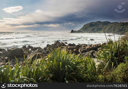 Beautiful Sunset at the Ocean Beach, New Zealand. Inspiring natural and travel background