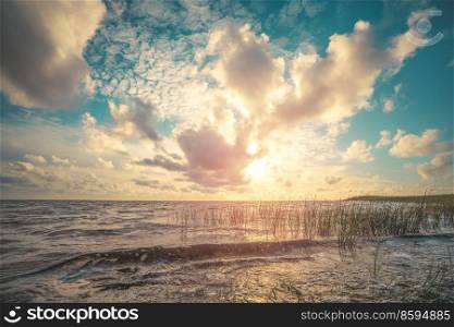 Beautiful sunset by the sea with a dramatic sky in a scandinavian seashore scenery