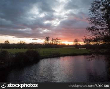 beautiful sunset dramatic sky country dedham river water red autumn; essex; england; uk
