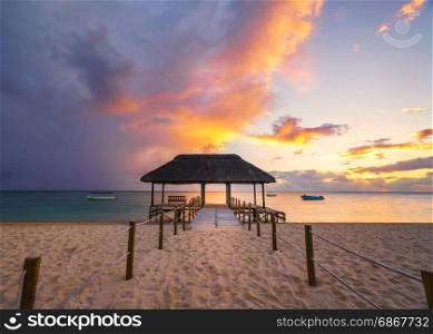 Beautiful sunset in Mauritius Island (flic en flac beach) with Jetty silhouette.