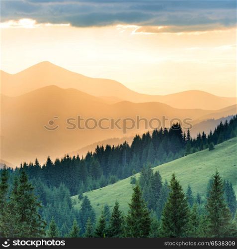 Beautiful sunset in the mountains. Landscape with sun shining through orange clouds. Beautiful sunset in the mountains