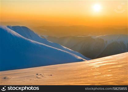 Beautiful sunset in winter mountains covered with snow. Nature landscape