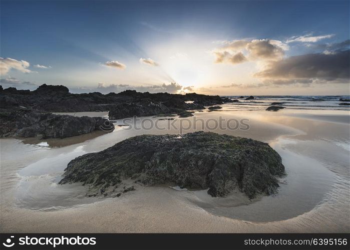 Beautiful sunset landscape image of Freshwater West beach on Pembrokeshire Coast in Wales