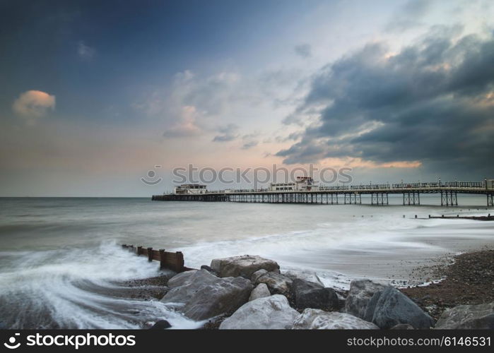 Beautiful sunset landscape image of pier at sea in Worthing England