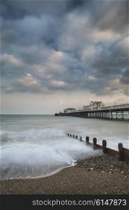 Beautiful sunset landscape image of pier at sea in Worthing England