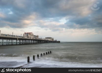 Beautiful sunset landscape image of pier at sea in Worthing England