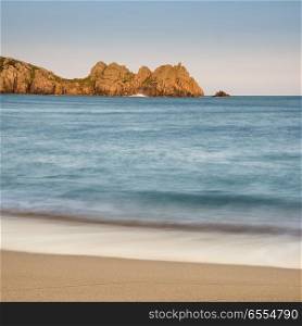 Beautiful sunset landscape image of Porthcurno beach on South Cornwall coast in England