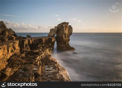 Beautiful sunset landscape image of Portland Bill rocks in Dorset England