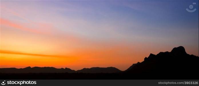 Beautiful sunset landscape with silhouette mountain