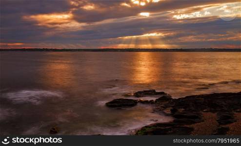 Beautiful sunset on a rocky ocean shore. Sunset on a rocky shore.
