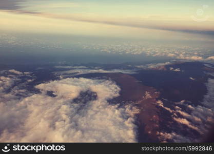 Beautiful sunset on the hill above clouds