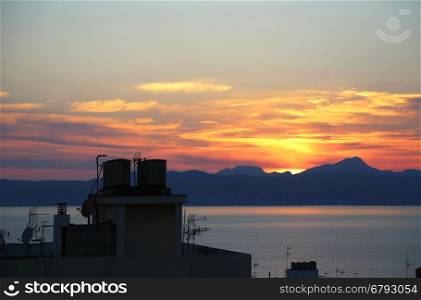 Beautiful sunset on the sea and top of roofs with antennas, Balearic Islands, Mallorca (Majorca), Spain