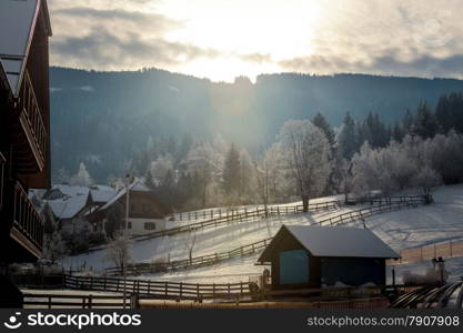 Beautiful sunset over highland Alpine village covered by snow