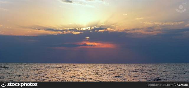 Beautiful sunset over sea surface. Four shots composite picture.