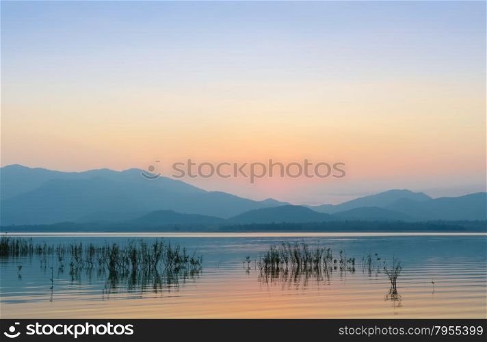 Beautiful sunset over the mountain with reflection on lake