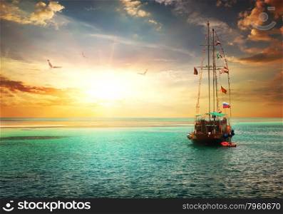Beautiful sunset over yacht in the sea