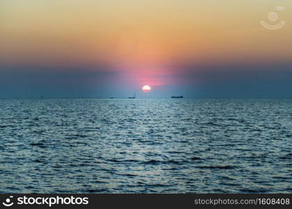 Beautiful  Sunset  Sky  above  the ocean  with reflection. Selective focus.