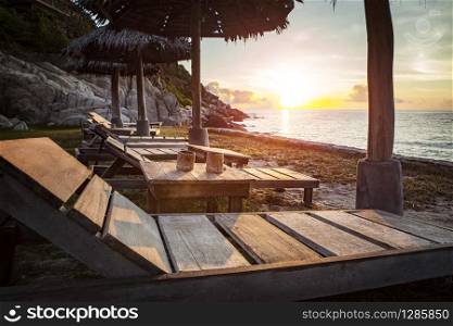 beautiful sunset sky and wood desk on sea beach