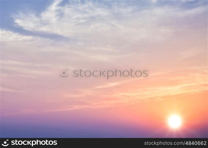 Beautiful sunset sky with bright sun and clouds