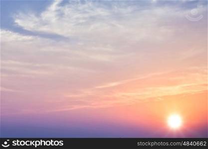 Beautiful sunset sky with bright sun and clouds