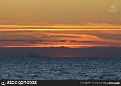 beautiful sunset with a big sailing boat