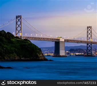 Beautiful sunset with Bay bridge and San Francisco Bay landscape in North California USA West Coast of Pacific Ocean, San Francisco United States Landmark Travel Destination cityscape concept.