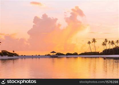 Beautiful sunset with palm trees silhouette and colorful sky on exotic island. Perfect white beach with turquoise water at ideal island