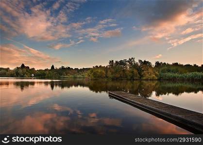 Beautiful sunsey sky reflected in Autumn Fall lake