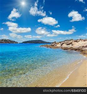 Beautiful sunshiny summer Aegean Sea rocky coast landscape, Sithonia (near Lagonisi beach), Halkidiki, Greece. Two shots stitch image.