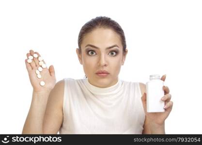 Beautiful surprised young woman showing question mark made from pills on her palm and holding a pills bottle