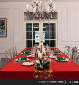 Beautiful table setting with Christmas decorations. Red colors. Interior of the room. christmas table decoration