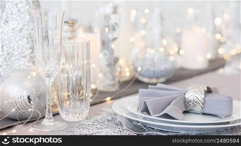 Beautiful table setting with Christmas decorations. Silver colors. christmas table decoration