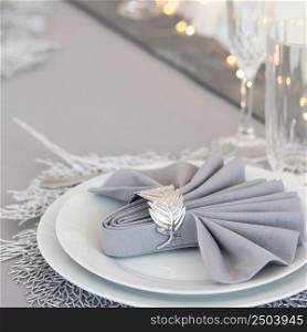 Beautiful table setting with Christmas decorations. Silver colors. christmas table decoration