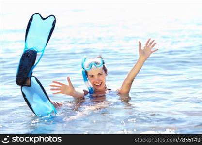 Beautiful tanned girl in snorkel gear in water