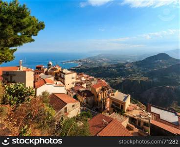 Beautiful Taormina sea coast panoramic view from Castelmola mountain village and Castelmola roofs, Sicily, Italy.