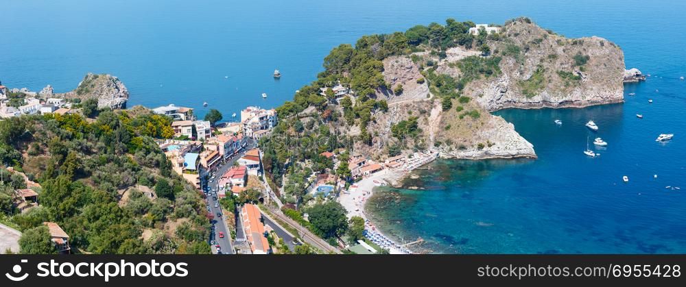 Beautiful Taormina view from up, Sicily, Italy. Sicilian seascape with coast, beaches and Grotta Azura. People are unrecognizable. Two shots stitch high-resolution panorama.