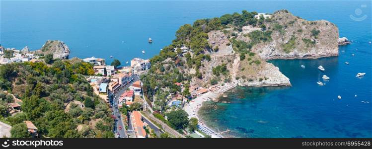 Beautiful Taormina view from up, Sicily, Italy. Sicilian seascape with coast, beaches and Grotta Azura. People are unrecognizable. Two shots stitch high-resolution panorama.