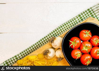 Beautiful tasty Italian pasta, tomatoes, onions and garlic for cooking pasta