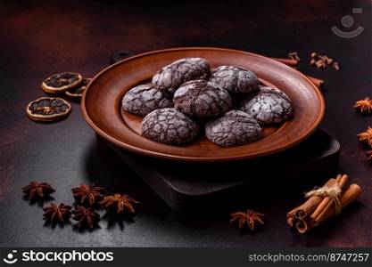 Beautiful tasty sweet cookie brownies on a brown plate on a dark concrete background. Beautiful tasty sweet cookie brownies on a brown plate
