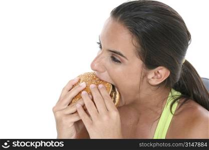 Beautiful Teen Girl Eating a Giant Cheeseburger after a workout.