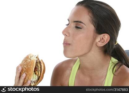 Beautiful Teen Girl Holding Colorful Weights and a Giant Cheeseburger.