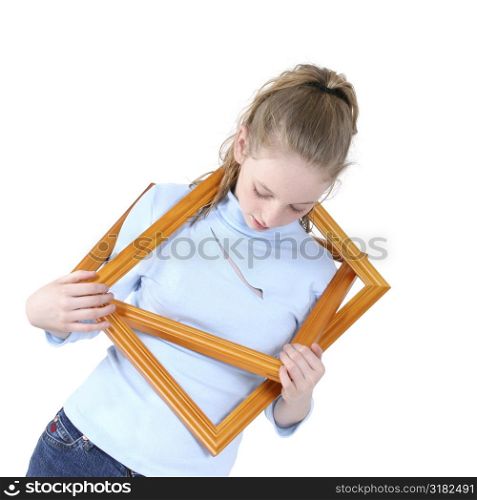 Beautiful Teen Girl Playing With Empty Picture Frames Over White.