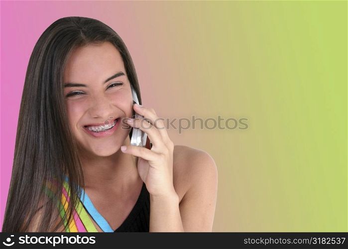 Beautiful teen girl smiling/talking on cellphone.