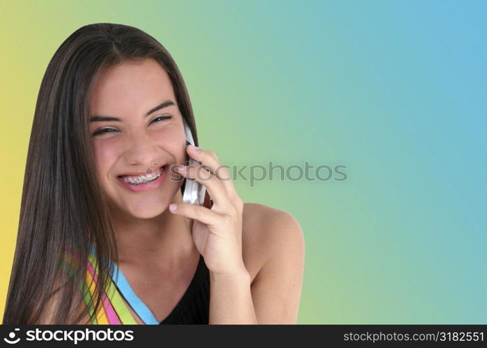 Beautiful teen girl smiling/talking on cellphone.