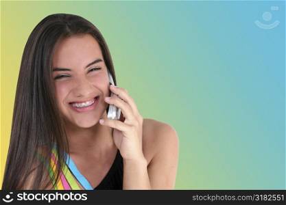 Beautiful teen girl smiling/talking on cellphone.