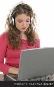 Beautiful Teen Girl with Headphones and Laptop. Listening and singing to music.